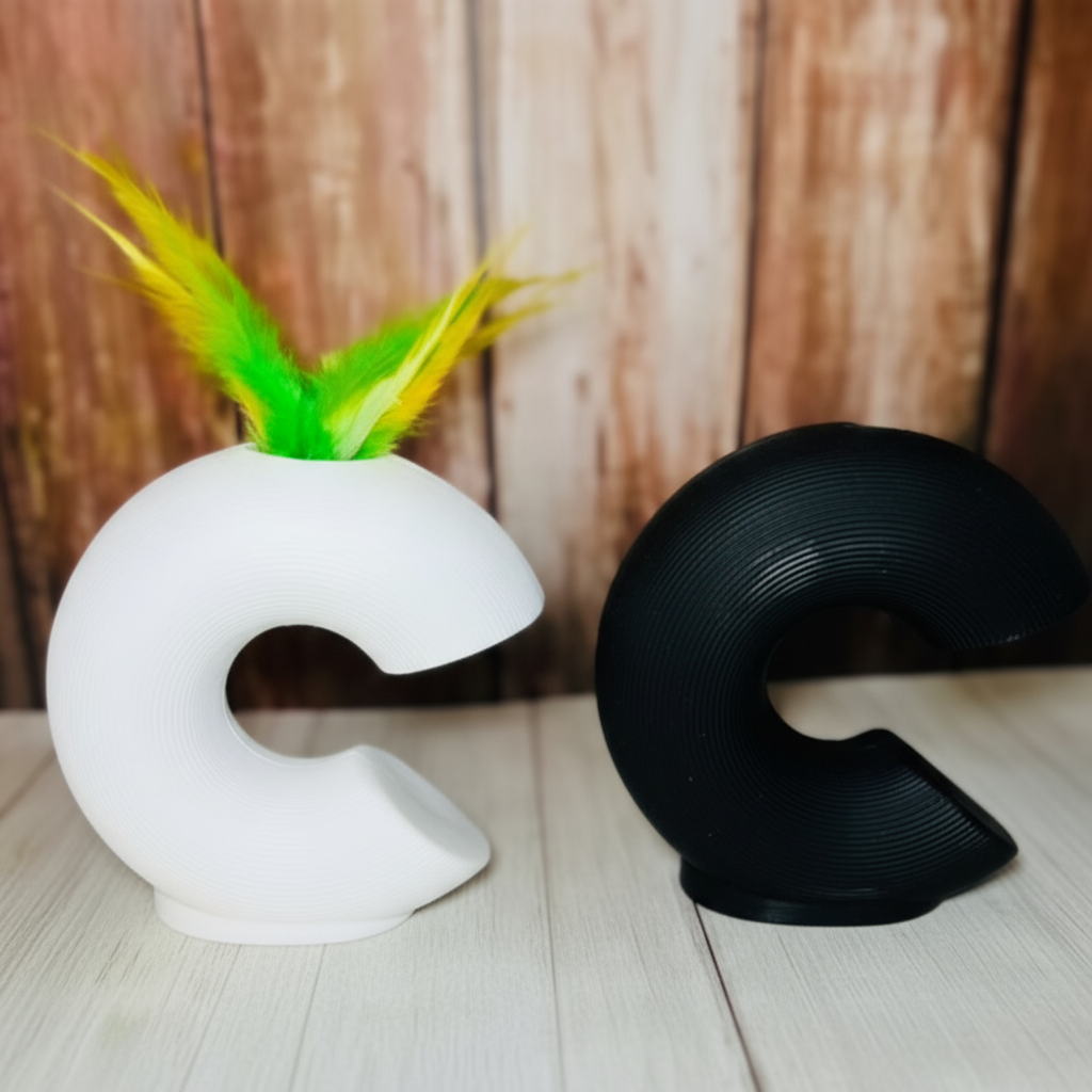 White and black pet toys with feathers on a wooden background