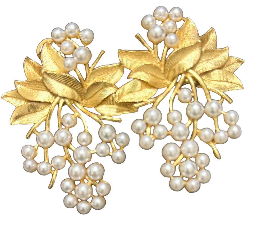Gold brooch with leaves and pearls on a white background