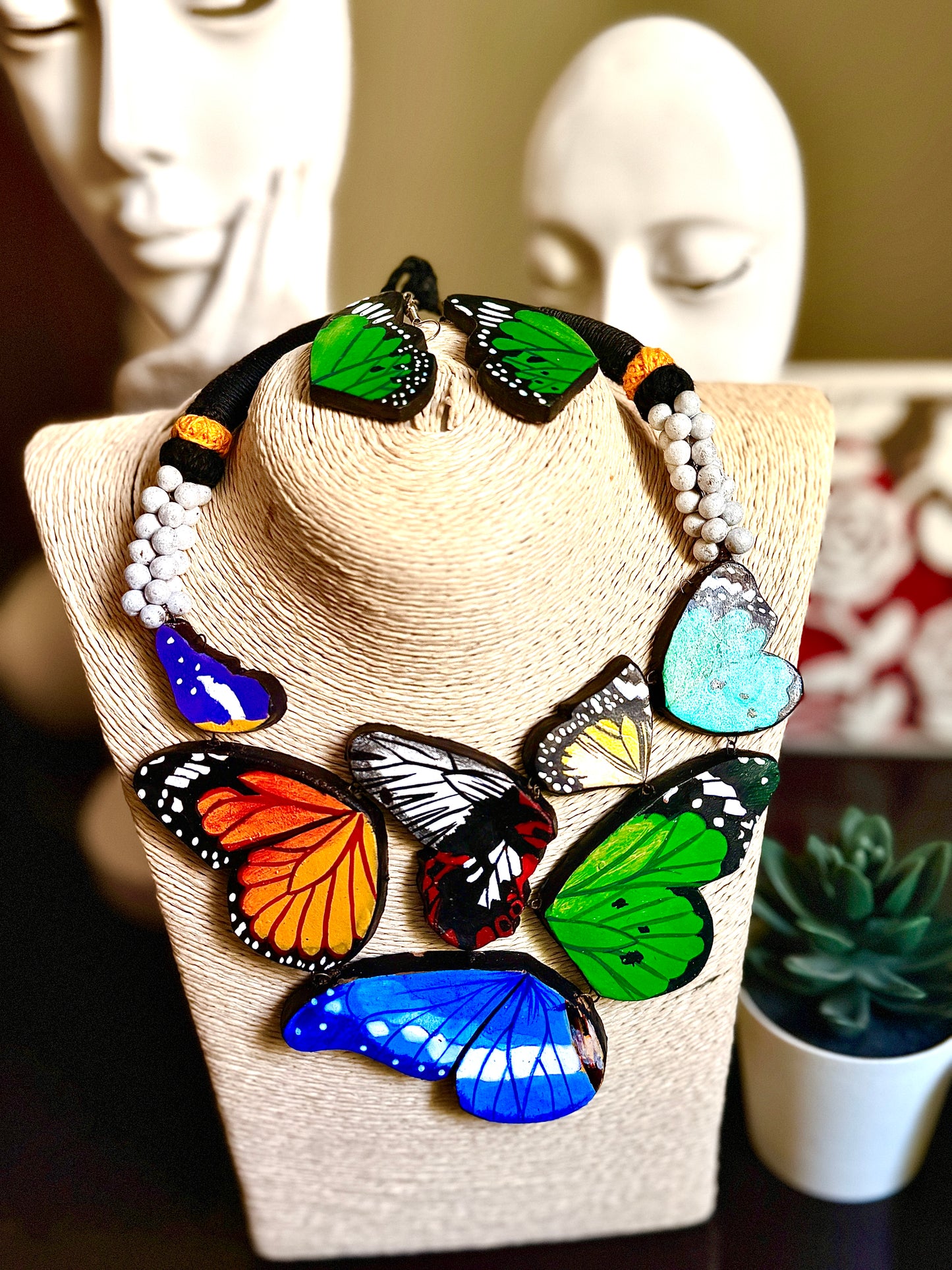 Necklace with colorful butterfly pendants on a mannequin bust
