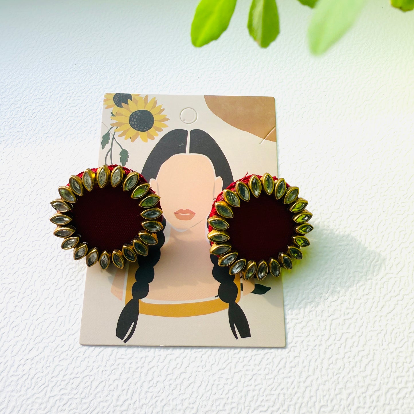 Pair of earrings on a display card with a white background