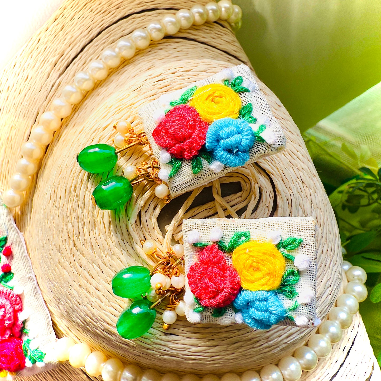 Colorful embroidered patches with floral designs on a textured surface.