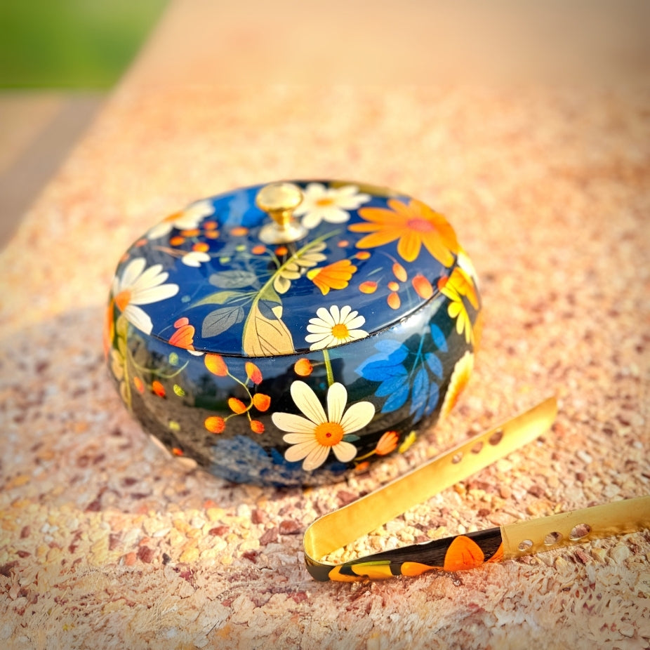 Decorative bowl with floral design on a textured surface