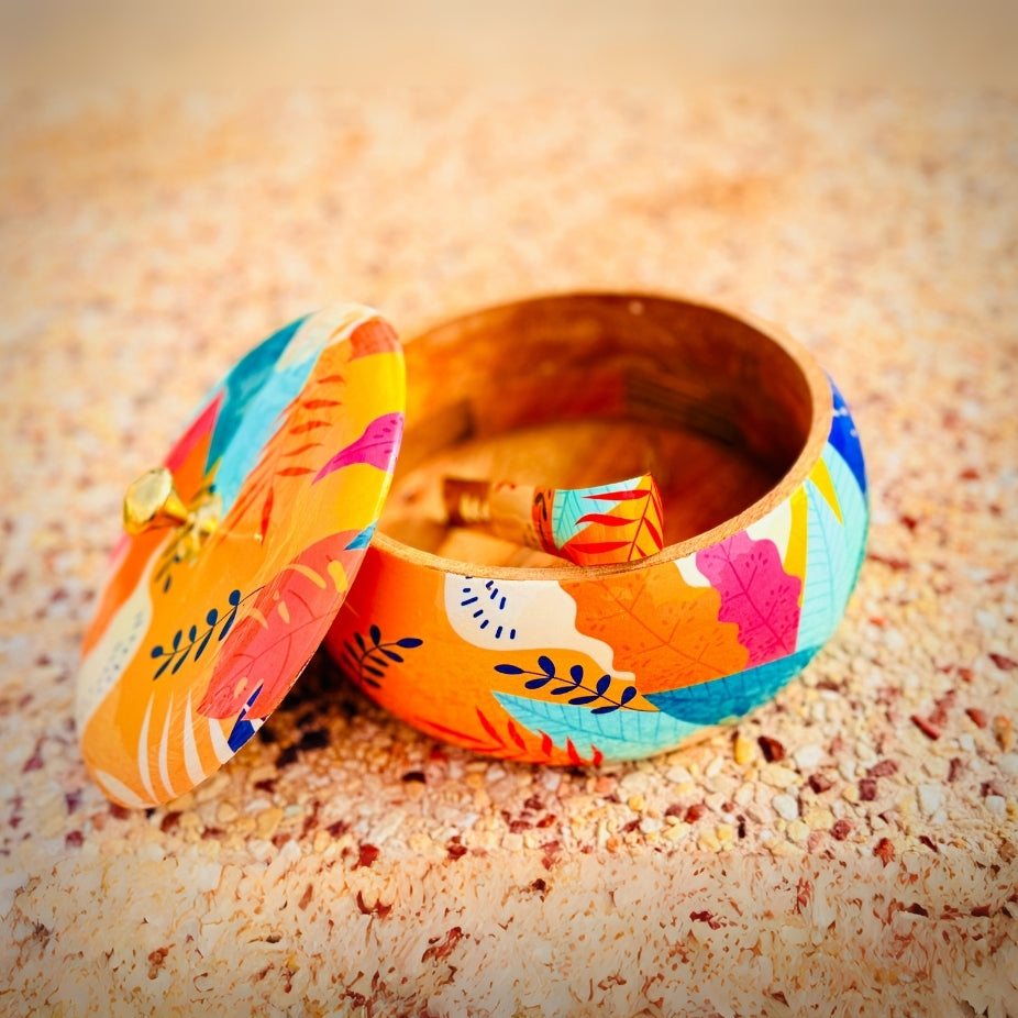 Colorful jewelry box with floral design on a textured surface
