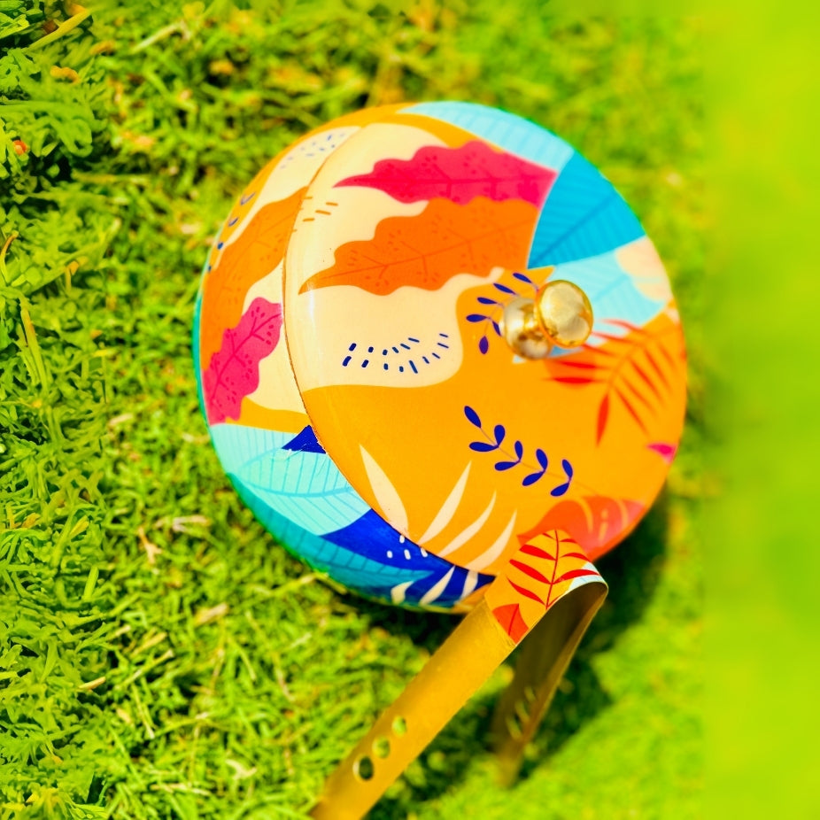Colorful handbag with floral design on a green grass background