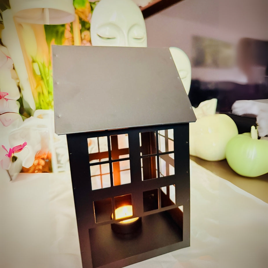 Decorative lantern with a candle inside on a table with a blurred background