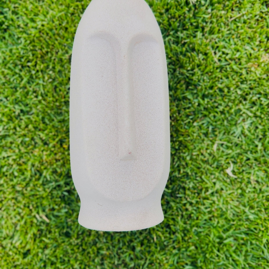 White ceramic vase on a grassy background