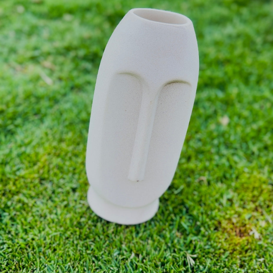 White ceramic vase on a grassy background