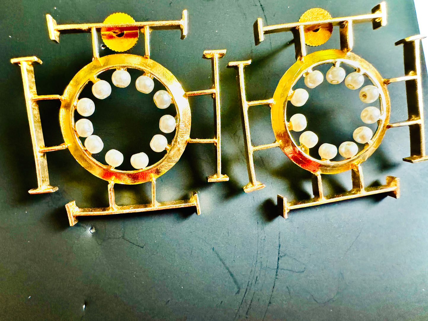 Two gold and white circular objects on a dark background