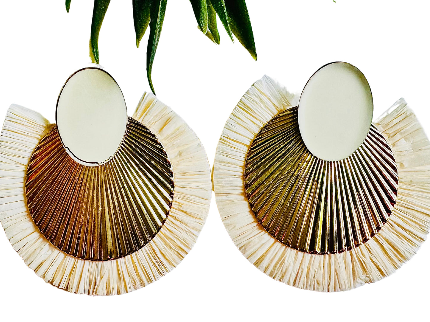 Pair of raffia earrings with a natural color scheme on a white background