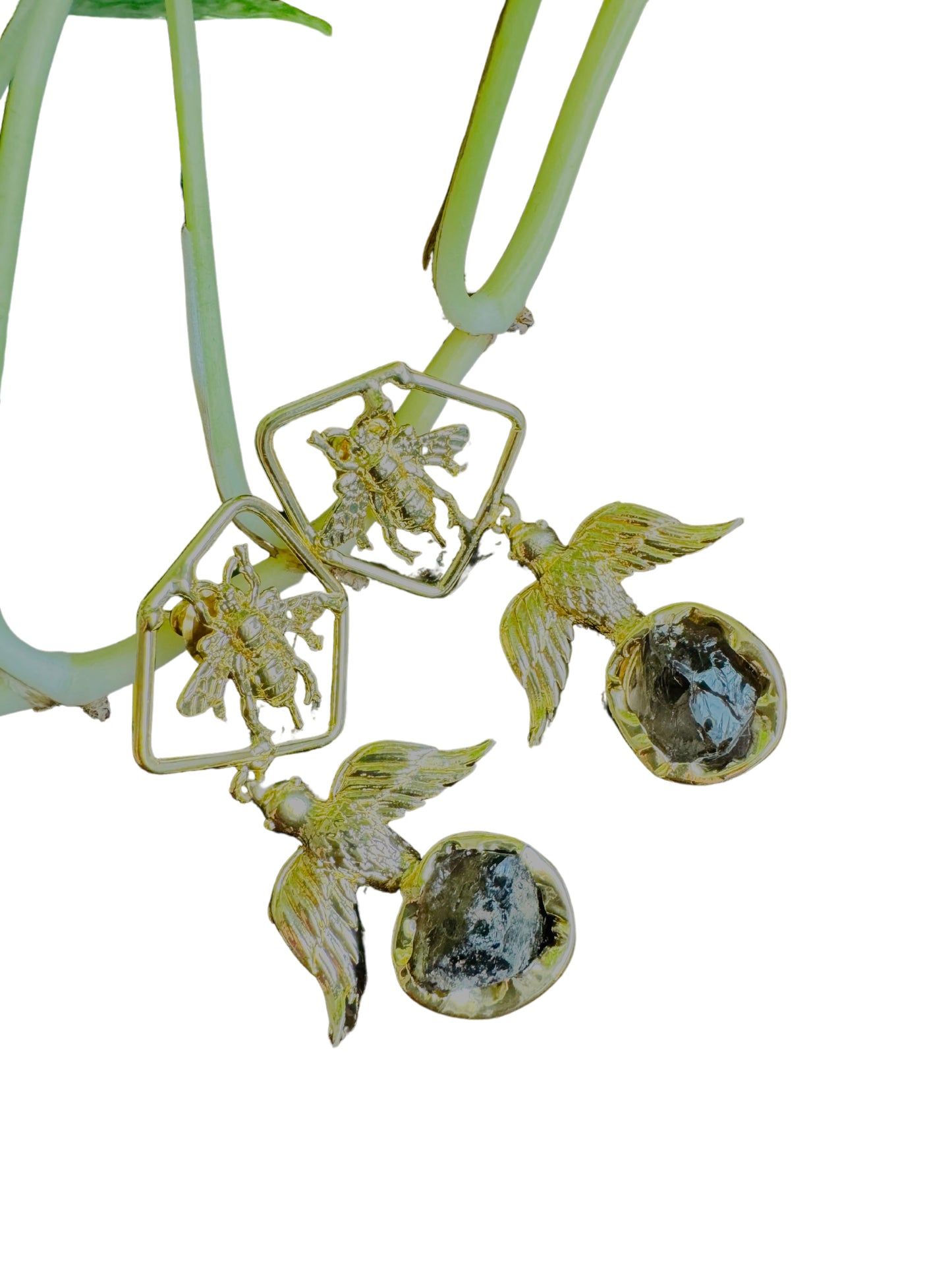 Gold fairy-shaped jewelry with gemstones on a white background
