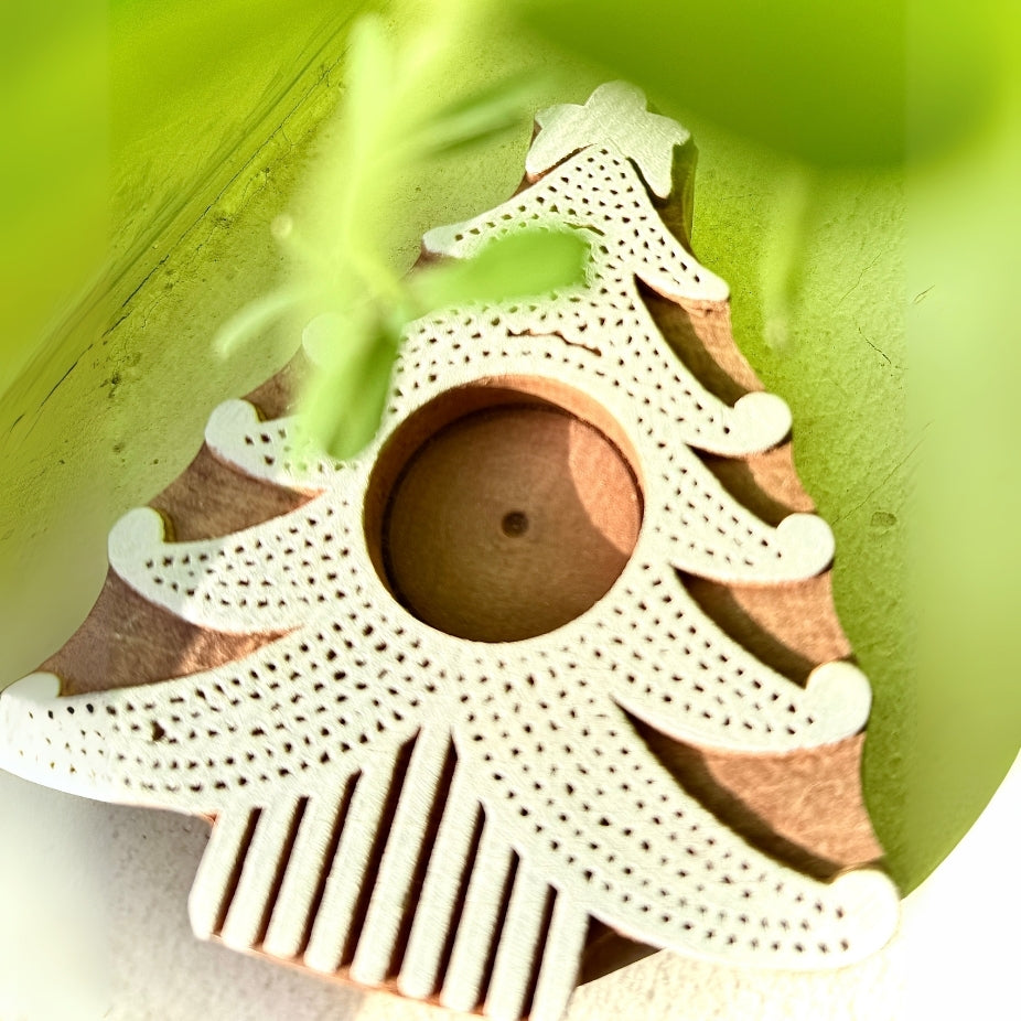 Decorative wooden Christmas tree ornament on a green background