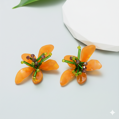 Orange flower-shaped earrings on a light gray background