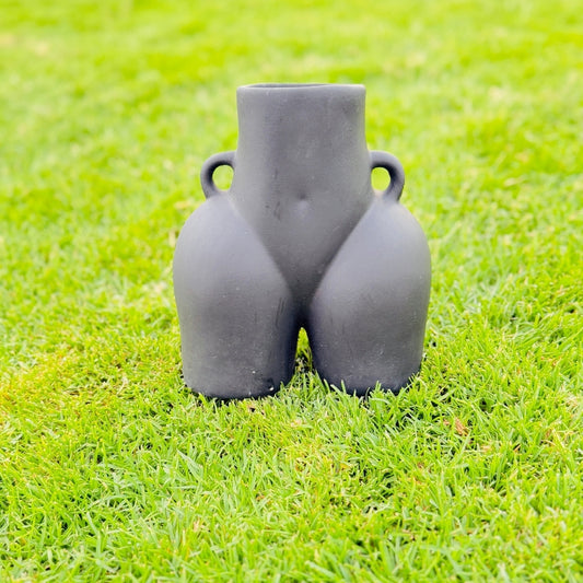 Gray ceramic vase on a grassy background