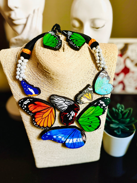 Necklace with colorful butterfly pendants on a mannequin bust.