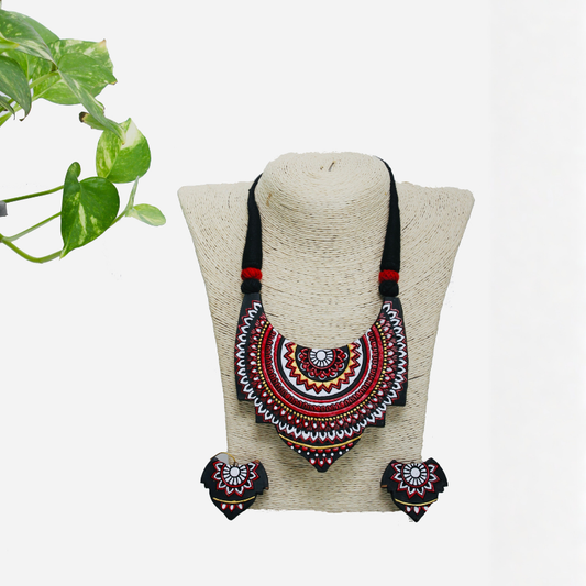 Decorative necklace and earrings set on a mannequin head with a white background