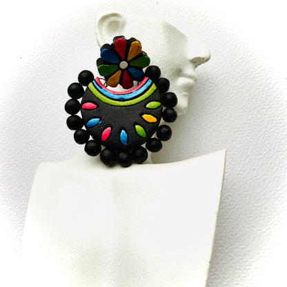 Colorful earrings on a white stand with a white background