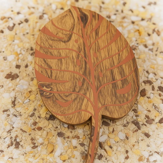 Wooden leaf-shaped object on a textured surface