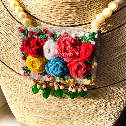 Colorful embroidered flower design on a textured surface