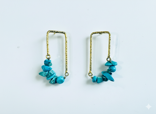 Pair of turquoise beaded earrings on a white background