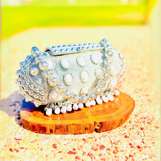 Unique handcrafted round Banjara metal handbag adding charm to traditional outfits
