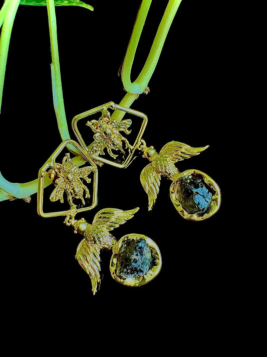 Gold necklace with fairy and crystal pendants on a black background