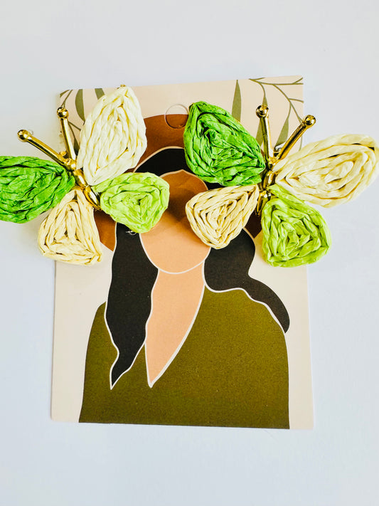 Card with butterfly design made of green and gold paper on a white background