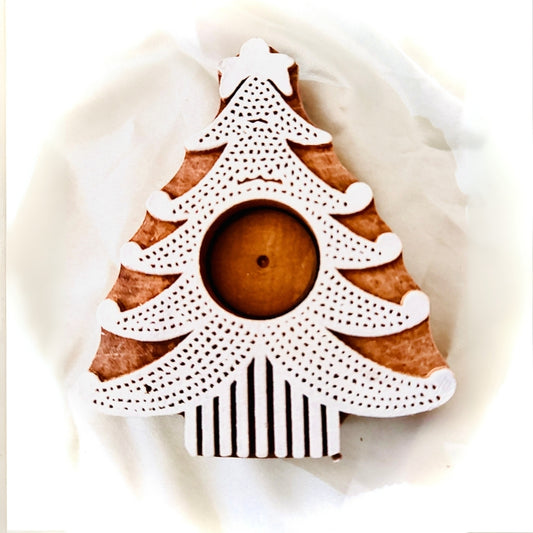 Decorative Christmas tree candle holder with brown center and white and black patterns on a white background